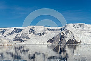 Antarctic seascape with icebergs and reflection