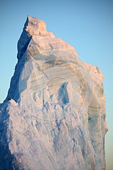 Antarctica blue iceberg in sunset