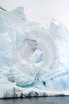 Antarctica - Non-Tabular Iceberg Floating In The Southern Ocean