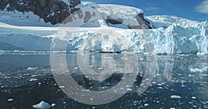 Antarctica towering glacier in icy lake aerial