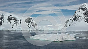 Antarkeic landscape with snowy mountains, glaciers and icebergs. Landscape of icy shores in Antarctica. Beautiful blue