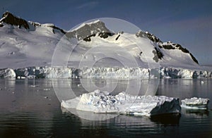 Argentine Antarctica An island of white ice floats on the surface of the blue sea water photo