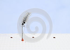 Antena on roof covered with snow photo