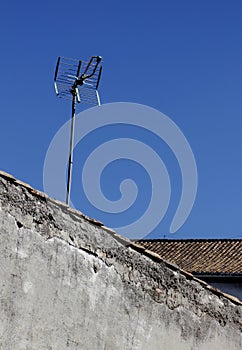 Antena on a roof of an old desolate house