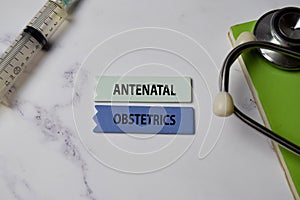 Antenatal Obstetrics text on Sticky Notes. Top view isolated on office background. Healthcare/Medical concept