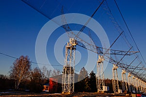 Antenna Array. A long row of radio telescopic antennas at the sunset