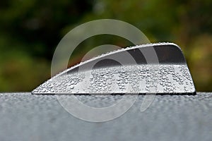 The antenna on a BMW 525, f11 whit raindrops