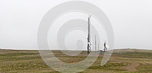 Antenna mast towards an overcast sky