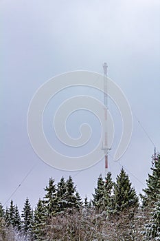 Antenna mast in wintertime and snowstorm Harz mountains Wernigerode Germany