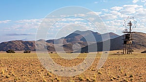 Antenna in the middle of nowhere with mountains in the back near Aus, Namibia.