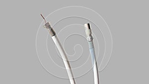 Antenna and TV cord on a gray background. PAL antenna cable, plug, antenna cord, type F, coaxial cable photo