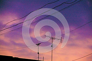 Antennas and cables with evening cloud sky