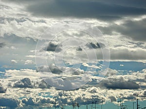 Antennas skyline under white clouds flying. Stratocumulus.