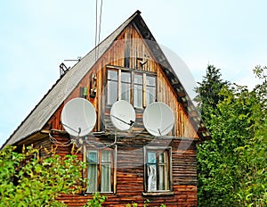 Antennas on a wall of the old wooden house