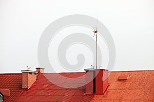 Antenne on red roof white sky