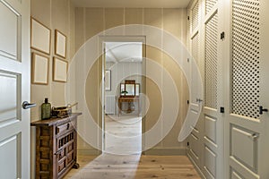 Anteroom with walk-in wardrobes for a double bedroom en suite with period wooden furniture