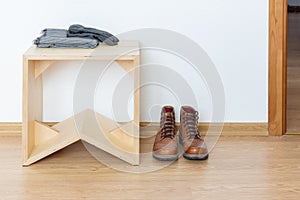 Anteroom with wooden stool and leather boots