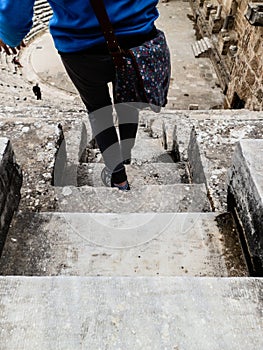 ANTHALYA, TURKEY, JULY 7,2017 Woman on stairs of Aspendos coloseum