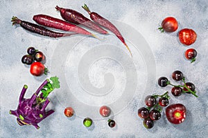 Anthocyanin-rich vegetables on light textured backdrop, top  view