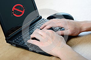 Anti Acta symbol on netbook and hands photo