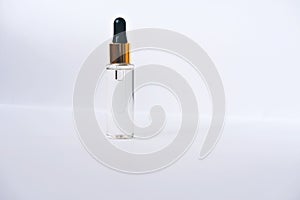 Anti age serum in glass bottle with droplet. Facial liquid serum with collagen peptides.