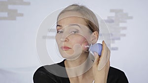 Anti-aging facial massage in office. Woman doing a face massage. beauty procedure, prevention of skin aging. vacuum