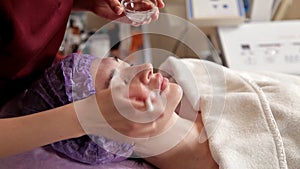 Anti-aging products for the face. The model receives a lifting massage at the Spa beauty salon. Exfoliation