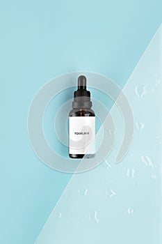 Anti aging squalane. serum with collagen and peptides on blue surface with shadows. Hyaluronic acid oil mockup. serum