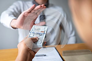 Anti bribery and corruption concept, Business man refusing and don`t receive money banknote in envelope offer from business peopl