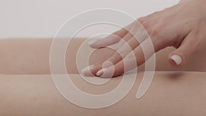 Anti cellulite care. Caucasian lady applying fat burning cream on her hips skin, enjoying spa procedures herself