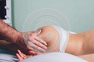 Anti-cellulite massage on the legs of young women.