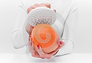 Anti-cellulite massager and orange.