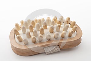 Anti cellulite therapy, deep tissue massage and spa treatment concept with handheld scrubbing wooden massager used to icrease