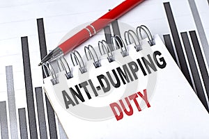 ANTI-DUMPING DUTY text on notebook on chart with pen