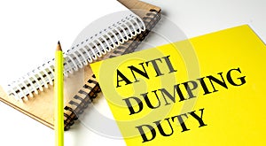 ANTI DUMPING DUTY text on yellow paper with notebooks