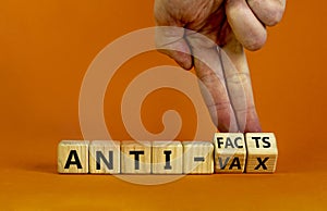 Anti-facts or anti-vax symbol. Doctor turns a cube, changes words `anti-vax` to `anti-facts`. Beautiful orange background. Cop photo
