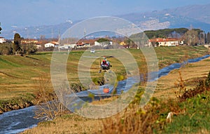 Vicopisano, Pisa, Italy - February 25, 2019: anti-fire helicopter loads water from the river on its bucket