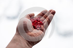 Anti-flue medicine. Red pills in hand.