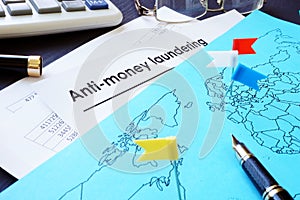 Anti-Money Laundering AML documents and world map.