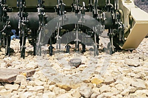 anti-personnel mine on the rocks. Mine clearance using armored mine clearance vehicle.