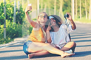 Anti-racism concept with happy multiracial girls having fun taking selfie from summer vacation
