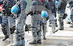 Anti-riot police cops with protective helmet during patrolling t