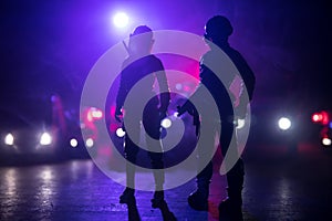 Anti-riot police give signal to be ready. Government power concept. Police in action. Smoke on a dark background with lights. Blue