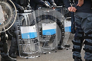 Anti-riot police officers with shields during security checks