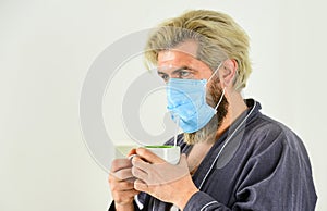 Anti-virus mask. Masks to protect from virus. Man wears mask to protect from viral infection. man drinks coffee in