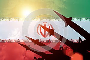 Antiaircraft rockets silhouettes on background of Iran flag.