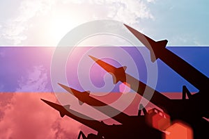 Antiaircraft rockets silhouettes on background of Russia flag.
