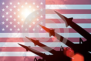 Antiaircraft rockets silhouettes on background of USA flag