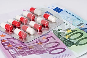 Antibiotic capsules in blister with euro banknotes
