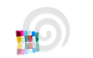 Antibiotic capsules pills in a row on white background